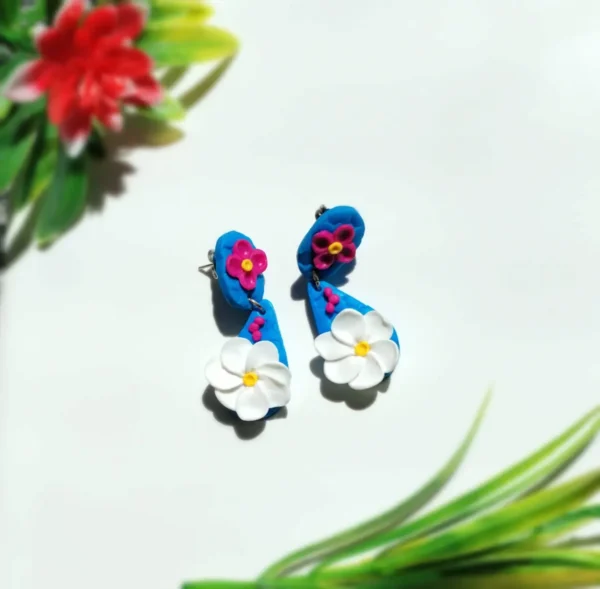 Blue Handcrafted Earrings with White Flower Design